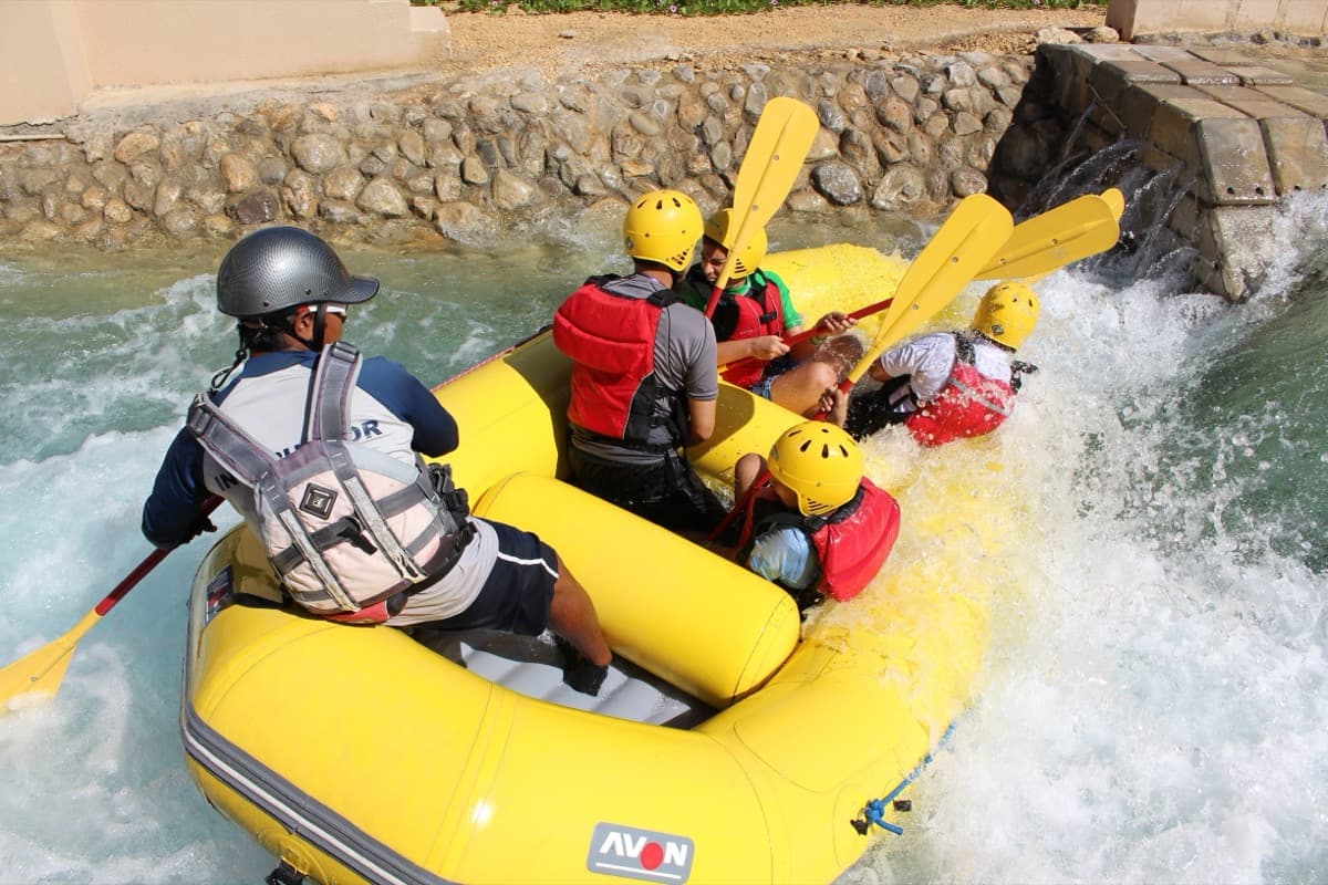 Students white-water rafting with an instructor